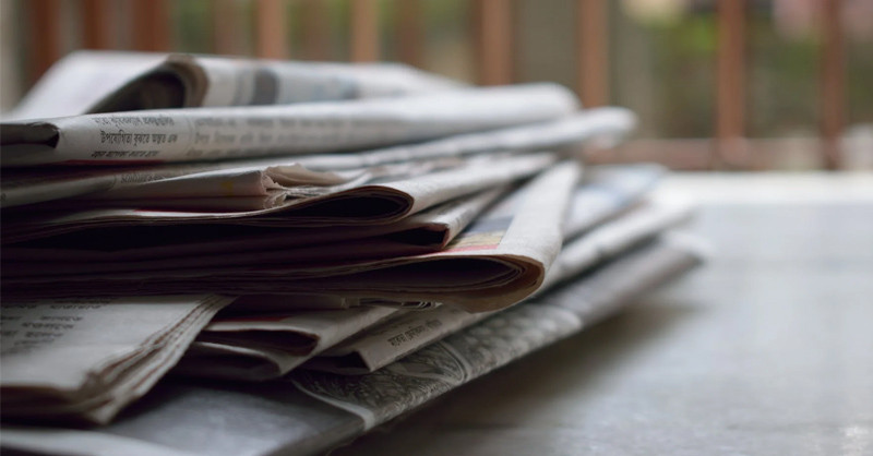 Newspapers stacked