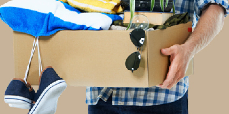 Man holding a box of possessions